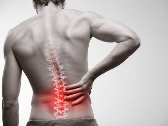 Physiotherapist helping a patient with lower back pain rehabilitation at Whitson Wellness in Amersham.